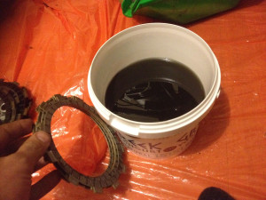 Preparing to soak new friction plates in old oil